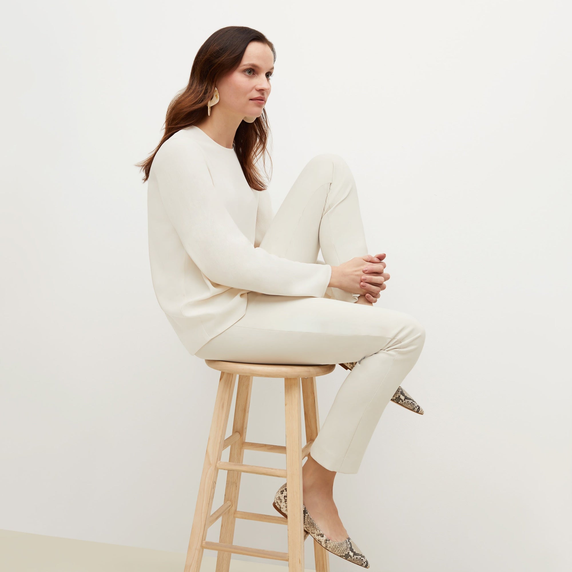 Side image of a woman standing wearing the foster pant in bone | Exclude