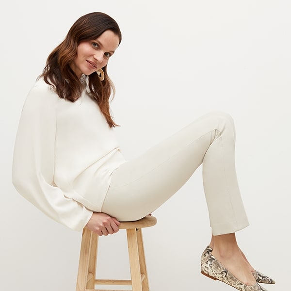 Side image of a woman standing wearing the foster pant in bone | Exclude