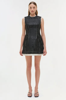 Black jacquard sleeveless mini dress with white trim hem and vertical seam details.