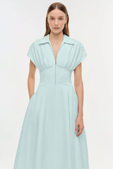 Light blue midi dress with collared neckline, short sleeves, fitted waist, and full skirt with front zip closure.