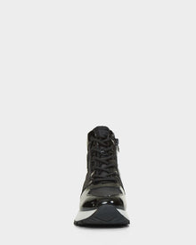 The CHELSA - L223505 Black by Rudsak is a black high-top sneaker with a shiny finish, shown facing forward on a white background. Its neatly tied laces and thick, sturdy sole highlight its sleek, stylish design.
