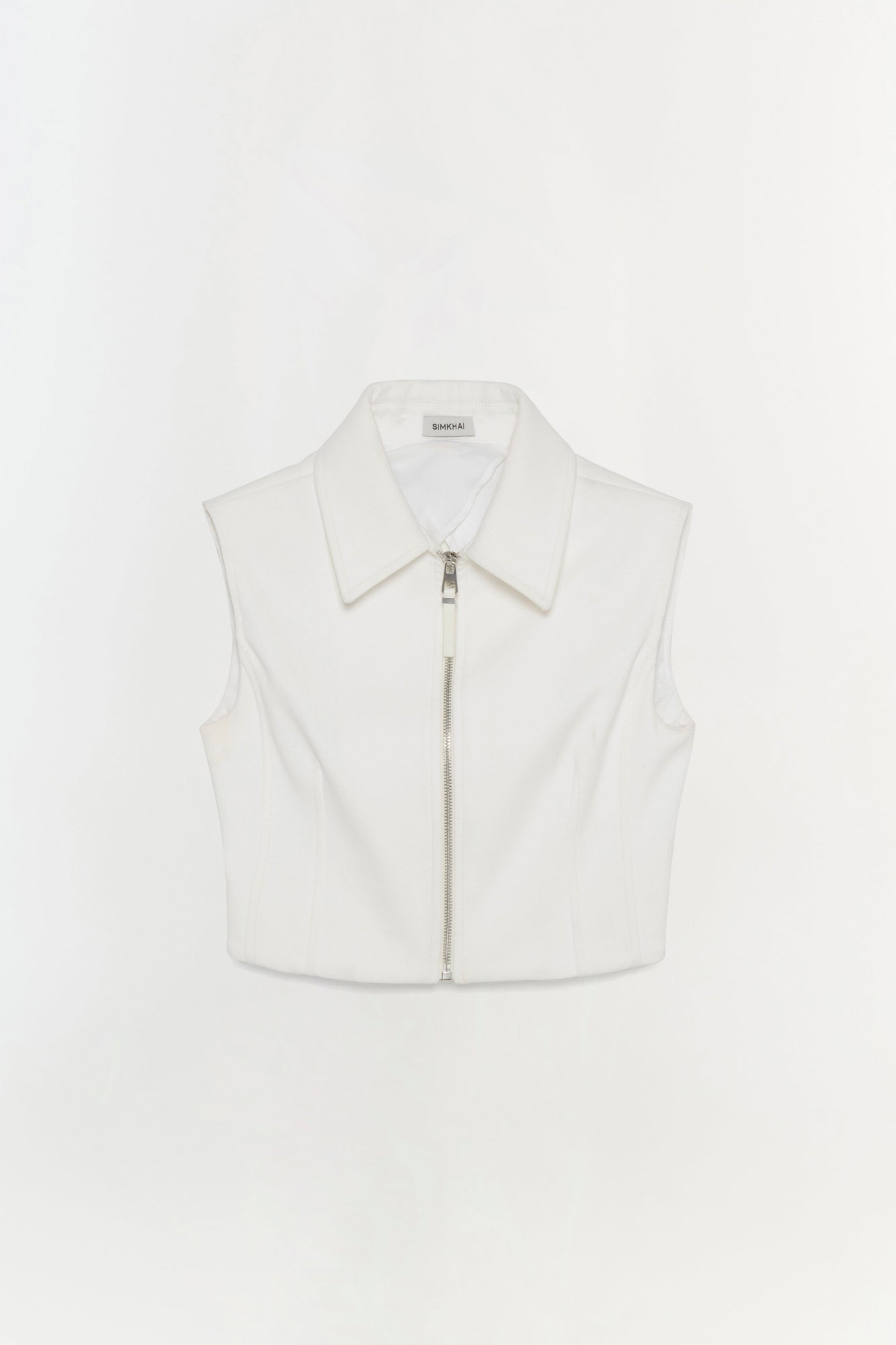 White sleeveless collared vest top with front zip closure.