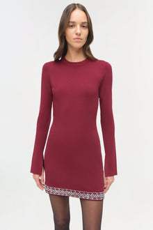 Burgundy knit mini dress with long sleeves and embellished trim at the hemline.