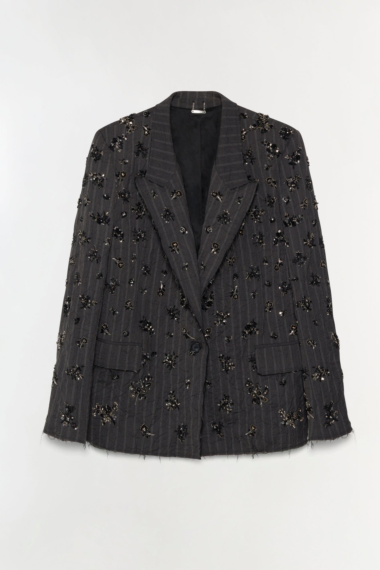 Charcoal pinstriped blazer with scattered black and gold beaded embellishments throughout and frayed edges.