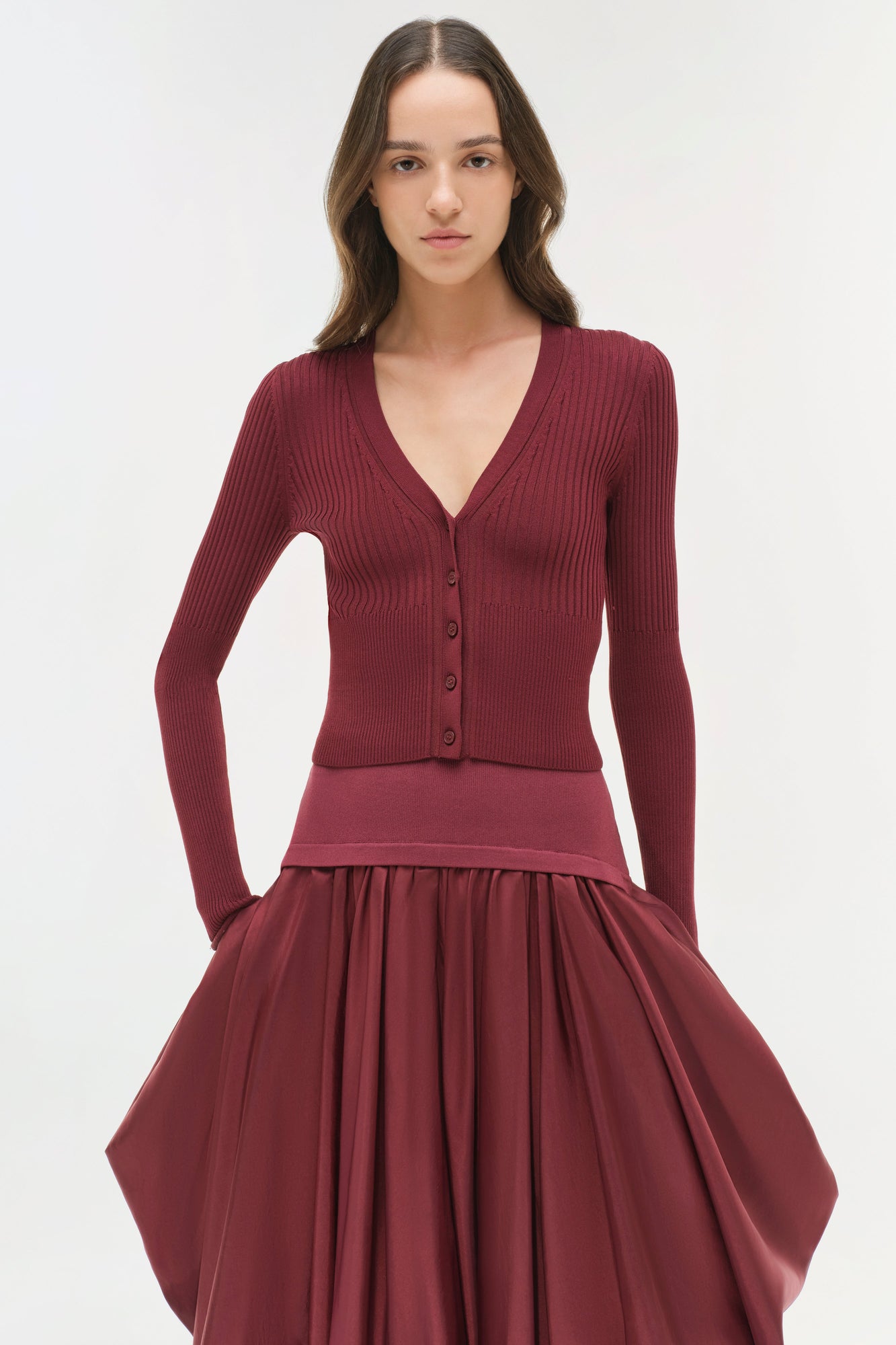 Burgundy midi skirt with gathered taffeta skirt and fitted knit waistband, styled with matching ribbed cardigan.