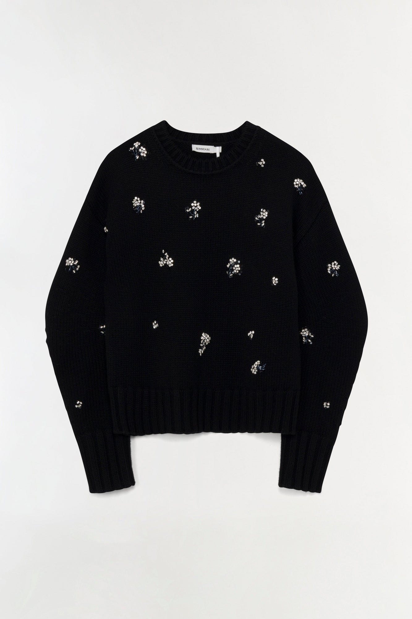Black ribbed knit crewneck sweater with scattered silver crystal embellishments throughout.