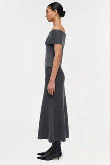 Charcoal gray wool off-shoulder top with short sleeves and fitted bodice, styled with a matching midi skirt.