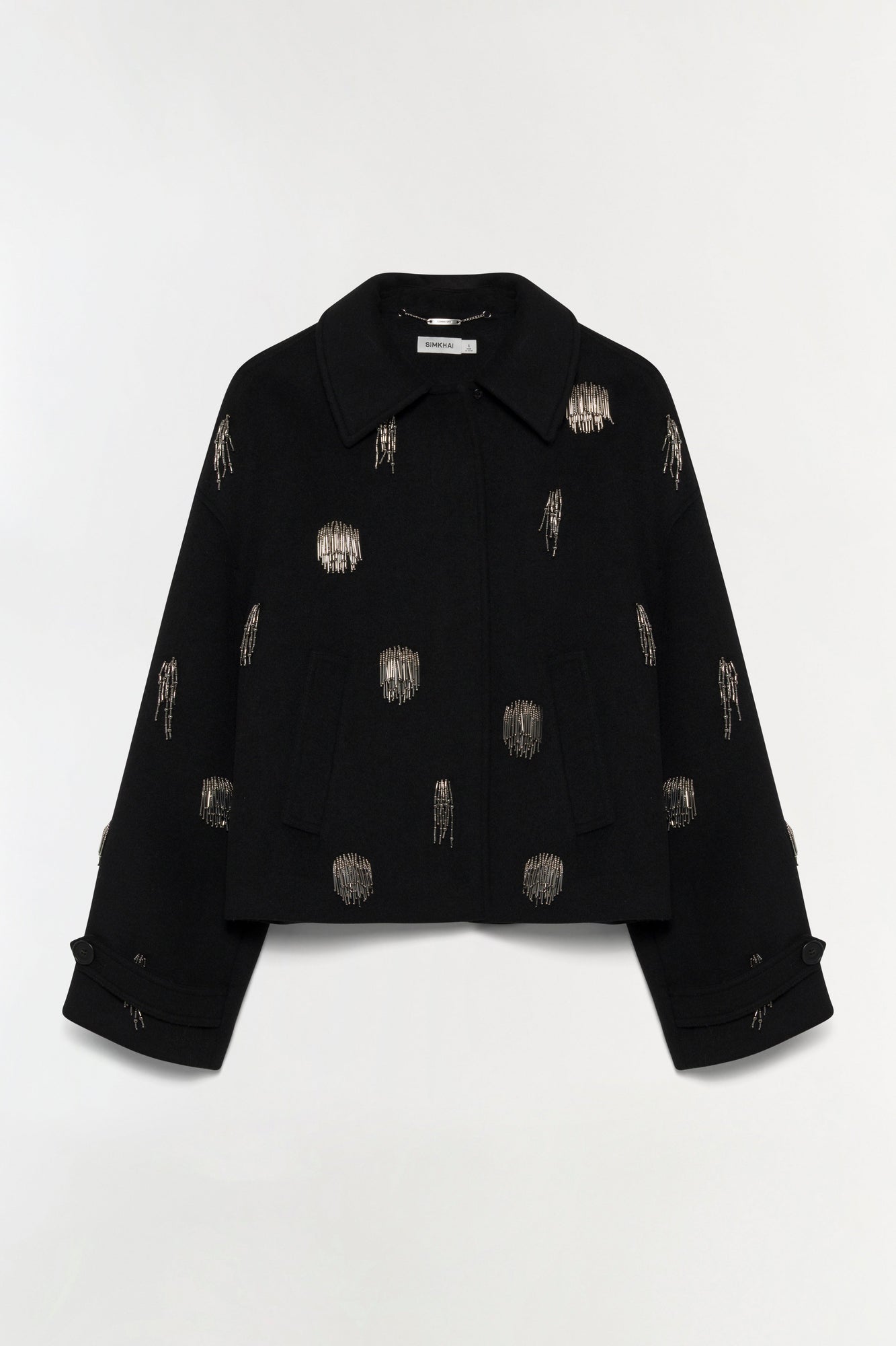 Black cropped jacket with silver beaded embellishments scattered across the front and sleeves.