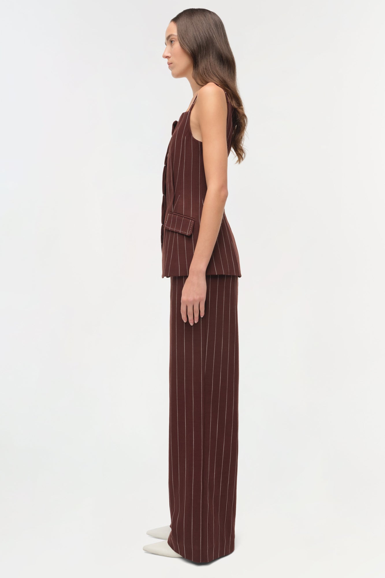 Woman wearing burgundy pinstriped sleeveless top with square neckline and matching wide-leg pants.