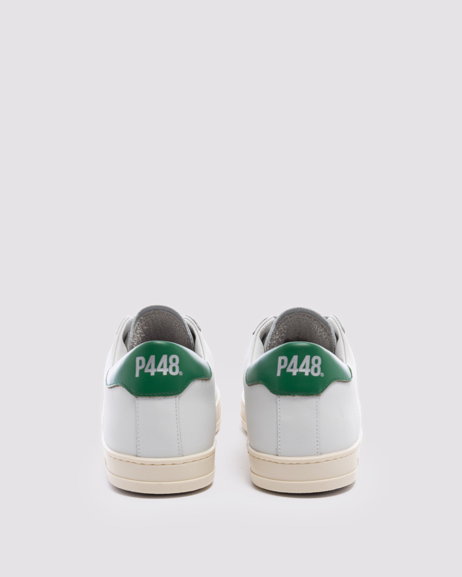 Back angle of white and  green sneakers