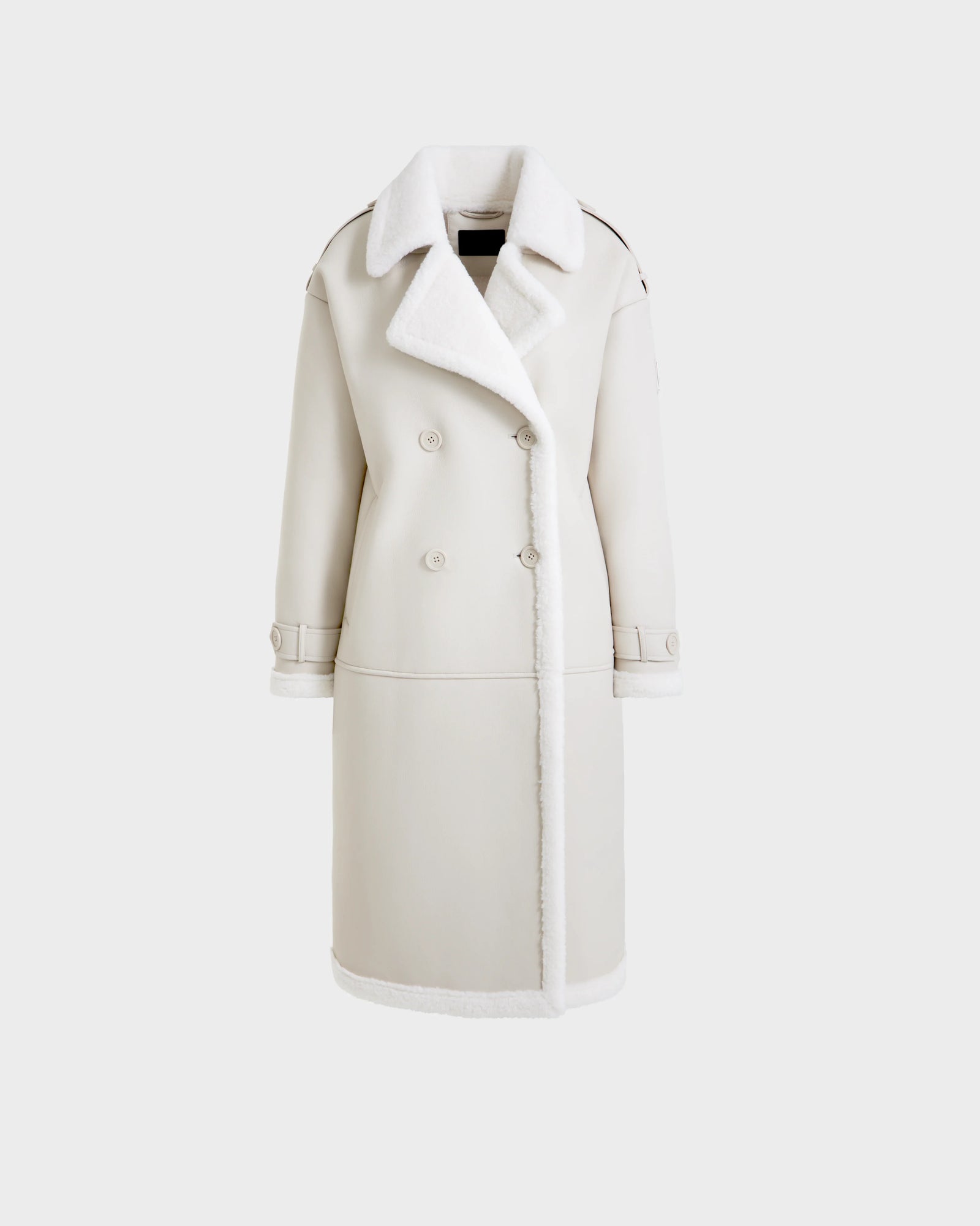 The Rudsak DARCY - L125539 Vanilla is a long, double-breasted vegan leather overcoat featuring a large white shearling collar and trim, buttoned front, and cuffed sleeves, shown against a plain white background.