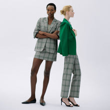 side image of a woman wearing the smith pant in check plaid