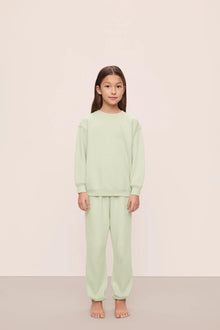 Model is wearing Kid's French Terry Sweatshirt and Jogger Set in  Matcha