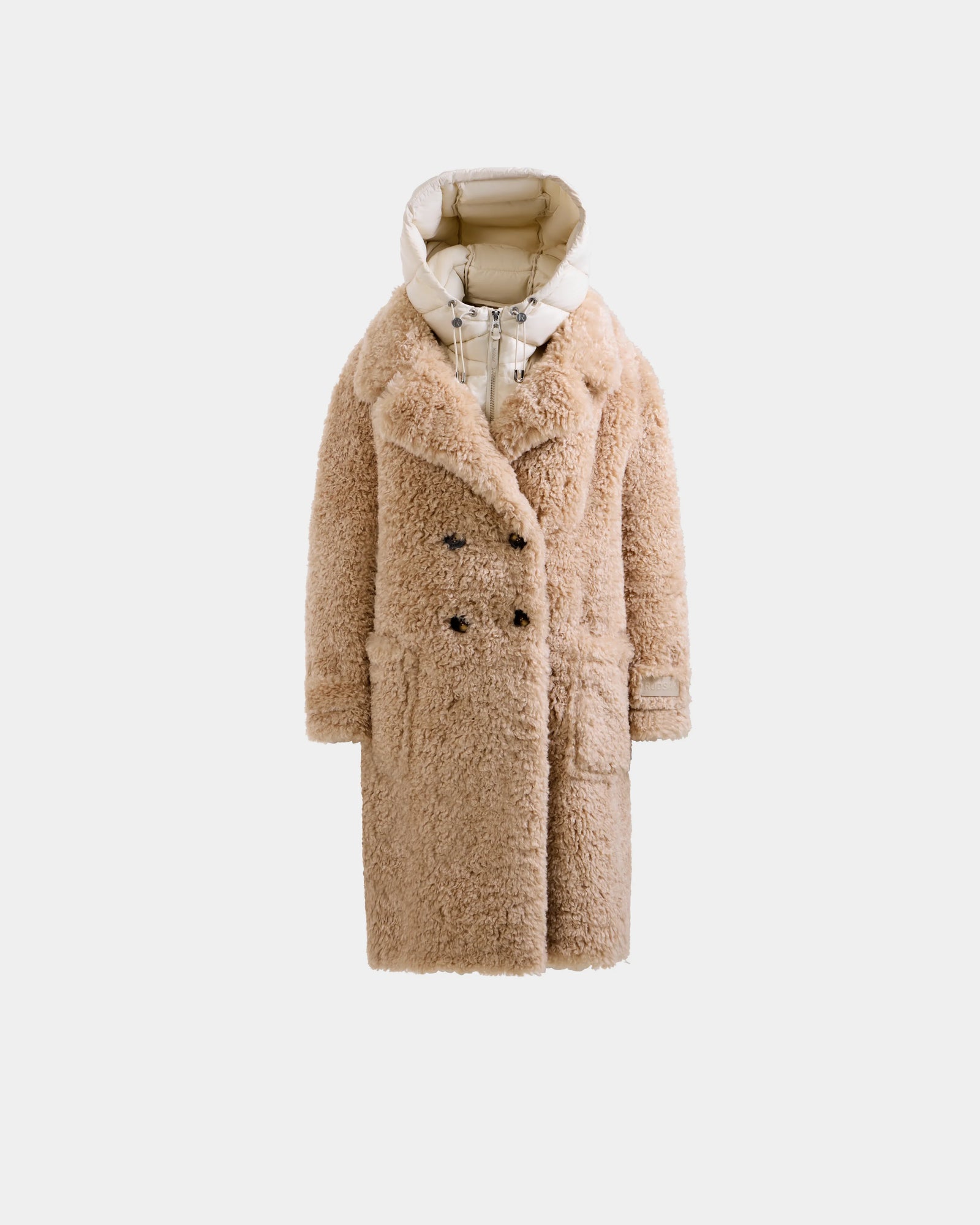 The Rudsak EMRYN - L125588 Vanilla is a beige women’s teddy jacket with large lapels, double-breasted design, front pockets, and a contrasting white padded hood and lining, showcased on a plain light background.