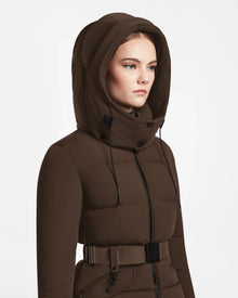 A woman wears the Rudsak ADELINE - 8124544 Mocha belted winter jacket with hood, looking forward with a neutral expression, photographed against a plain white background.