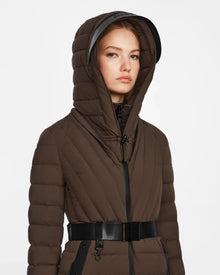 A woman wears the Rudsak ALISA - L124506 Espresso quilted down puffer winter coat with hood up and vegan leather belt, standing against a plain white background.