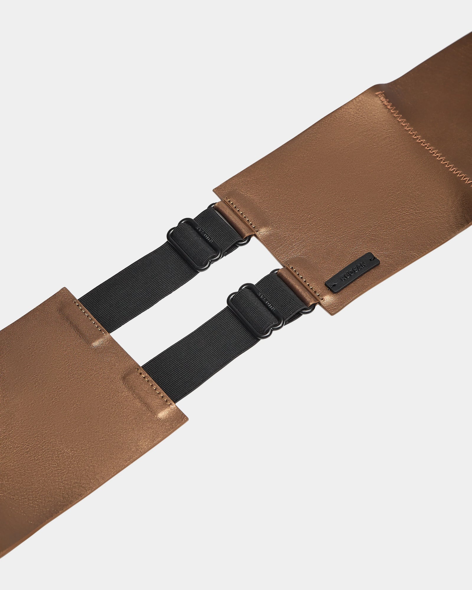 The Rudsak ALLEA - 8424506 Antique Bronze is a brown leather waist belt for women, featuring two rectangular pouches, black elastic straps, and statement buckle closures. Displayed on a white background.