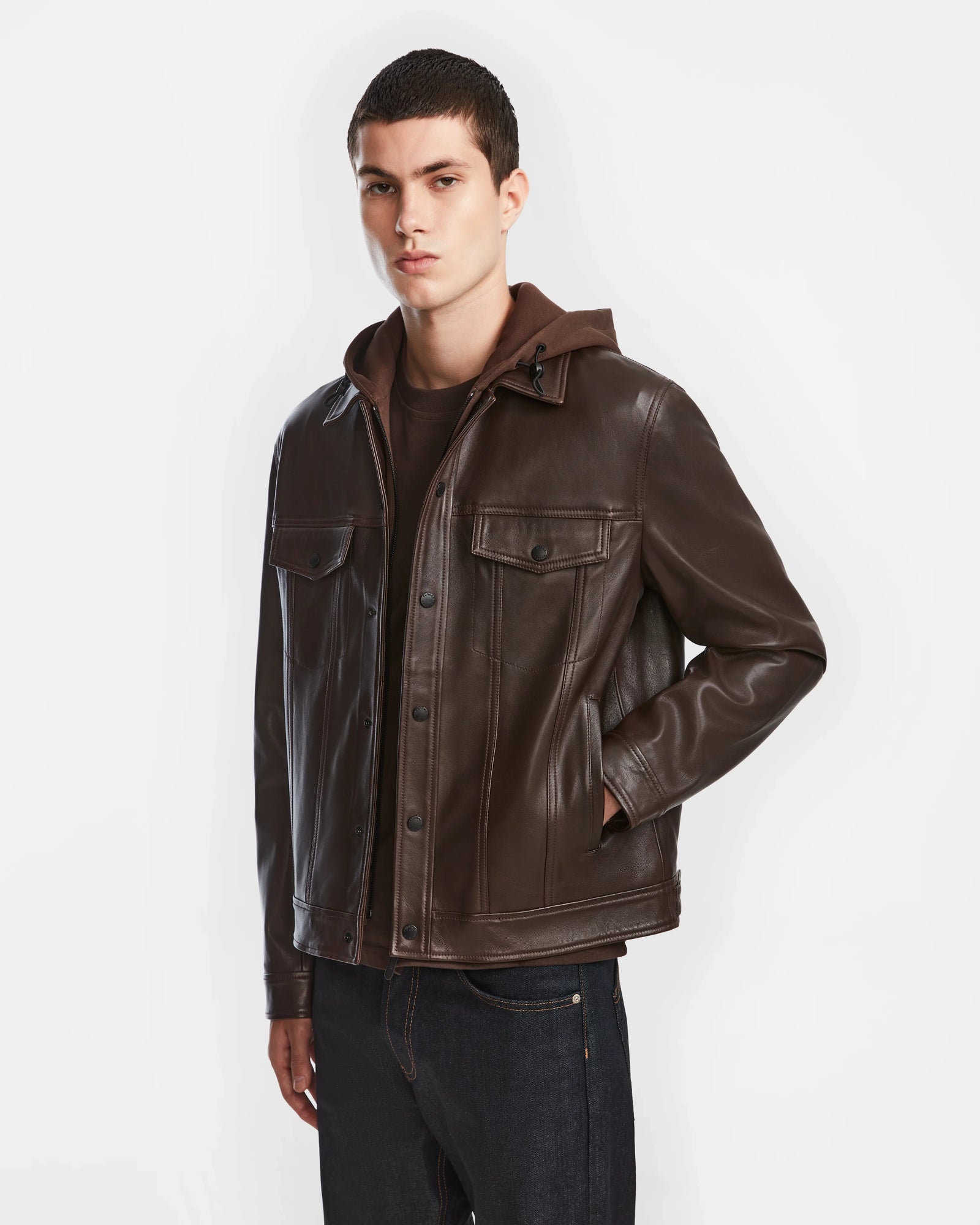 A man in a Rudsak AREN - 6124580 Espresso men’s leather shirt jacket with a hoodie dickie.