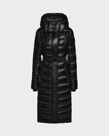 The Rudsak FRIDA L-S - L124525 Black is a long women's quilted maxi down puffer coat with a belted waist, hood, and high collar, shown on a light gray background—an elegant addition to your winter wardrobe.