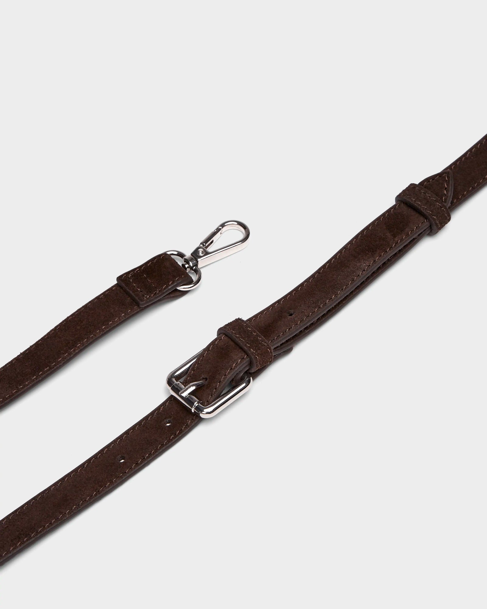 A close-up of the PREYA - 8324508 Espresso strap by Rudsak, featuring brown leather with silver metal hardware—buckle and clasp—laid flat on a white background.