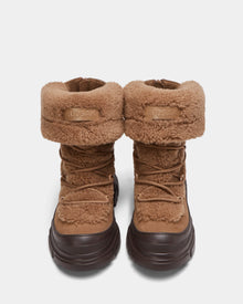 The ROKI - 8224533 Camel by Rudsak are womens winter ankle boots in brown faux shearling with chunky dark brown soles, front laces, folded cuffs, and the Rudsak logo on the cuff.