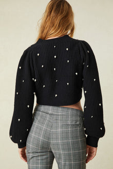 weater features pearl and crystal embellishments all over the front and the long blouson sleeves 