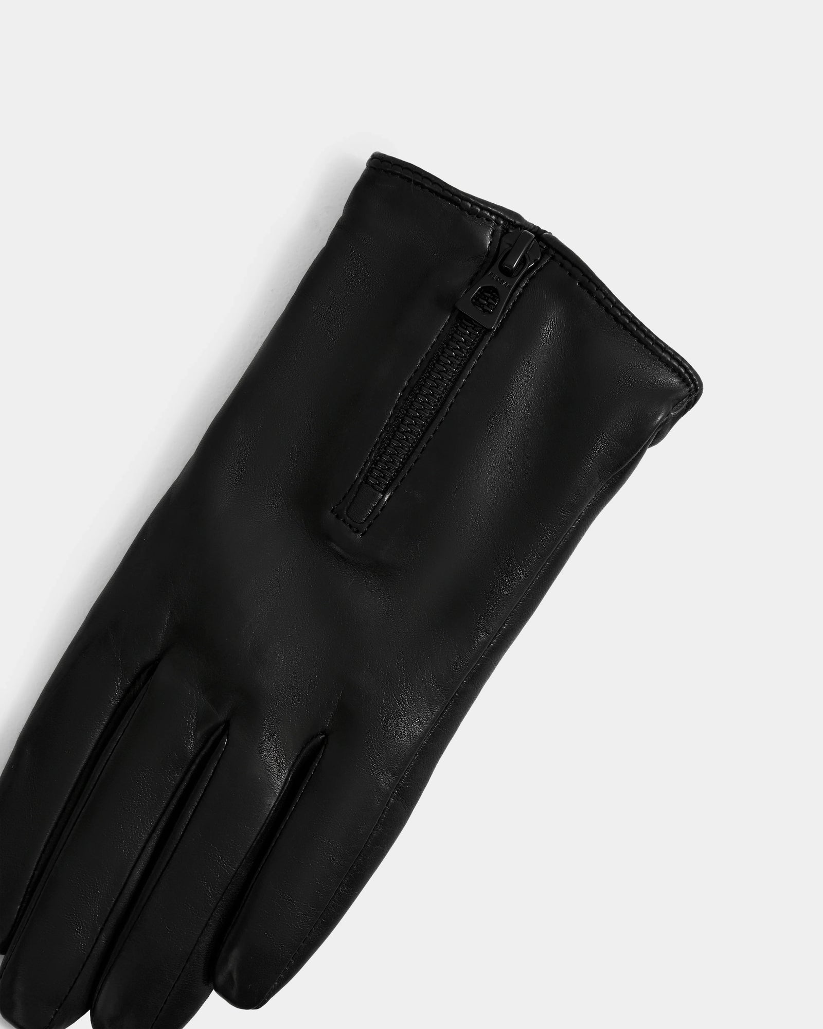 The Rudsak AUGUSTA - L425546 Black women’s glove, made from supple lamb leather with a sleek top zipper, stands out as a stylish cold-weather essential against a plain light gray background.