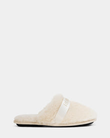 The Rudsak FLUFF - L223509 Cream is a women’s cream-colored faux-fur slipper with a fuzzy finish, flat black sole, and white top strap—ideal for cozy downtime—shown in side profile against a plain white background.
