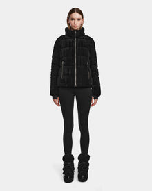 A person stands facing forward, wearing the MIRRY FF - L124507 Black womens short down puffer jacket with black leggings and black winter boots against a plain white background.