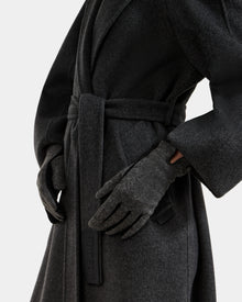 A person wears the OLGA - L425541 Grey coat by Rudsak with matching women’s wool gloves, standing against a plain background with one hand on their hip. Only their torso and arms are visible.