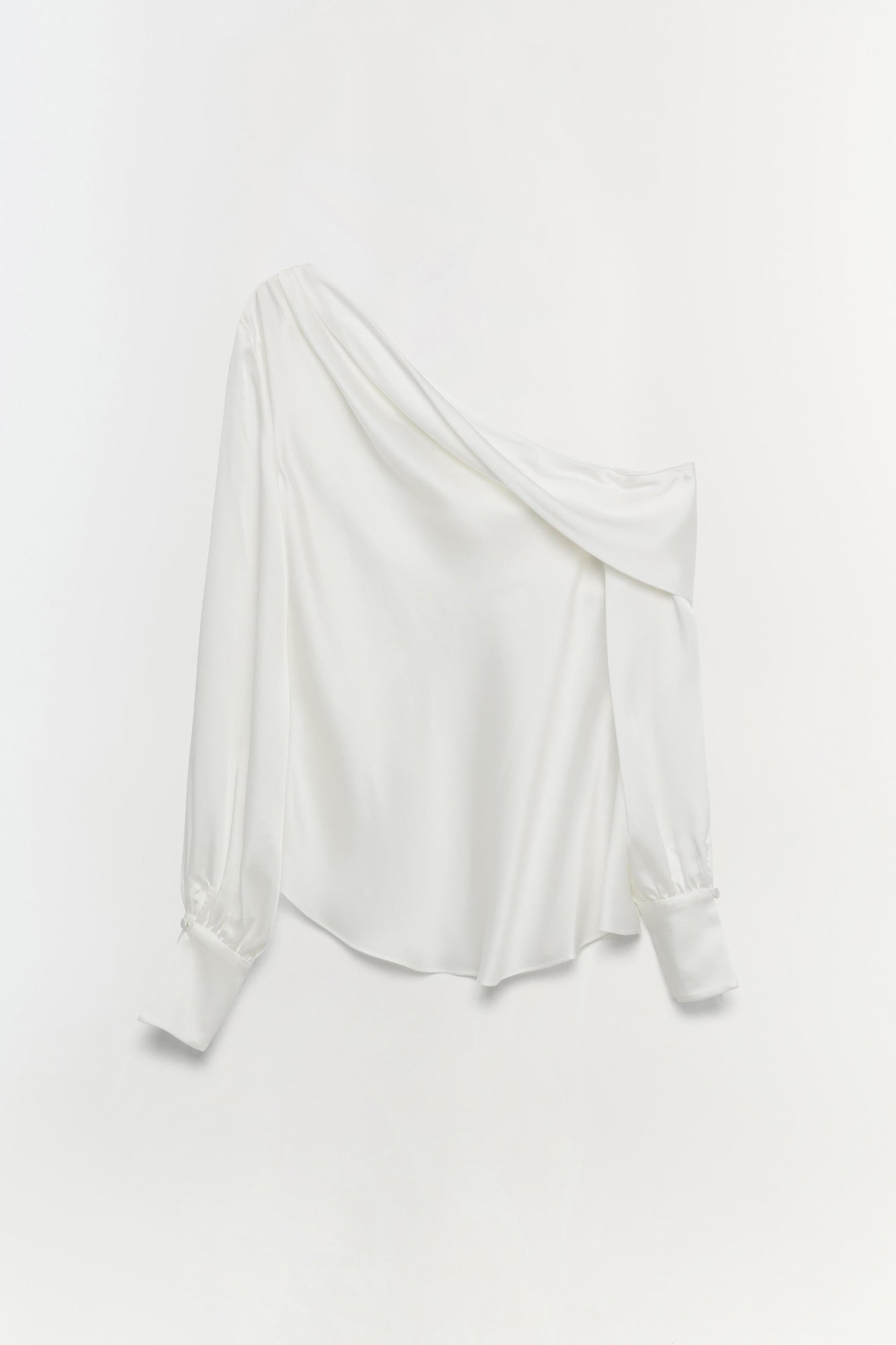 White off-shoulder top with draped neckline and long puffed sleeves.