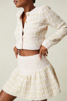 Model wearing cream tweed mini skirt 