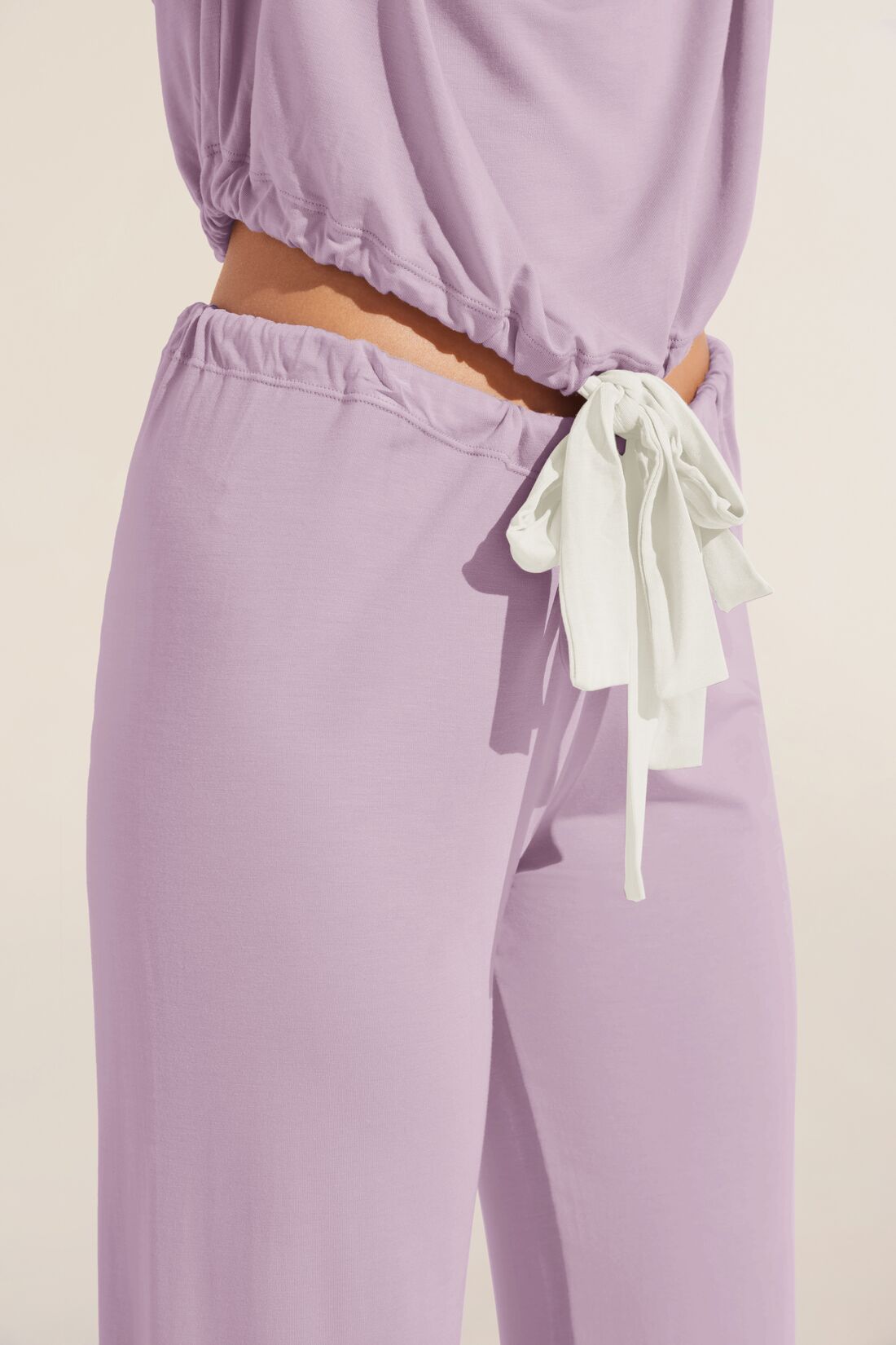 Model wears Gisele TENCEL Modal Slouchy PJ Set in lavender/ivory.