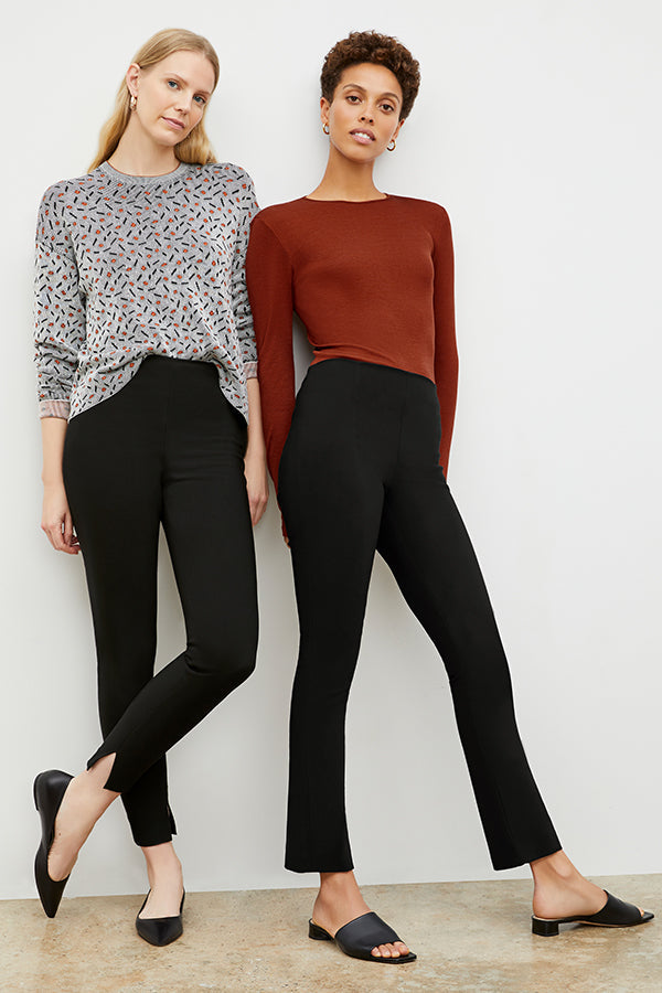 Front image of a woman standing wearing the Foster Pant in Black and a woman wearing the Foster Skinny in Black | Exclude