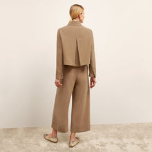 back image of a woman wearing the nicky jacket in saddle