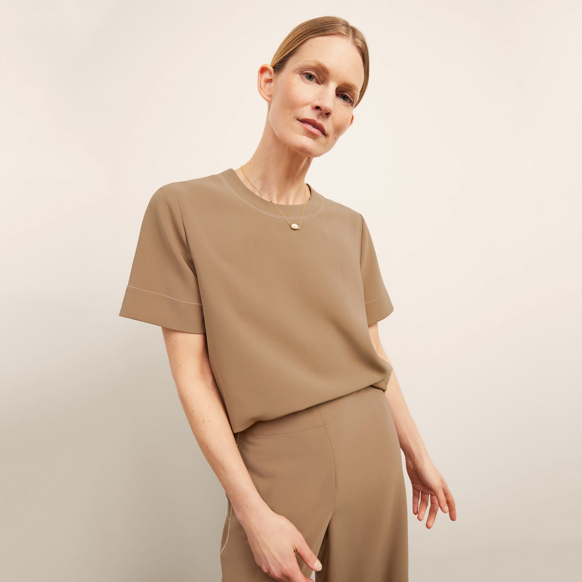 front image of a woman wearing the annika top in saddle | Lead