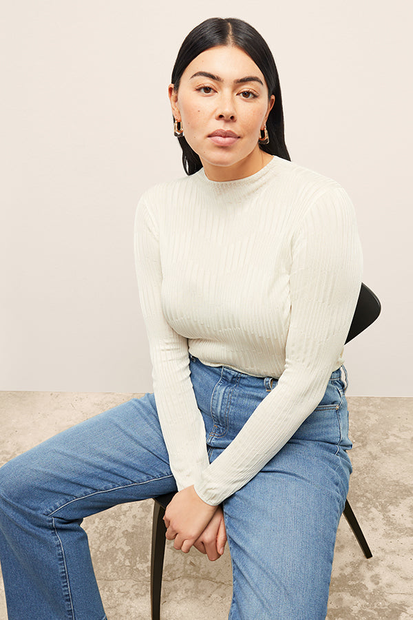 front image of a woman wearing the brodie top in ivory | Exclude