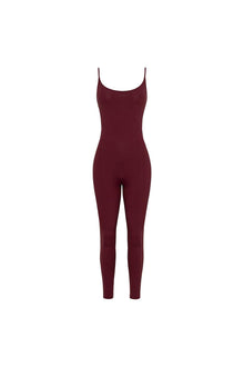 Maroon long-sleeved bodysuit with thin straps and tapered leg design displayed on a flat white background.