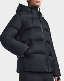 A person wearing the Rudsak DANIEL M - M123510 BLACK mens travel-friendly coat.
