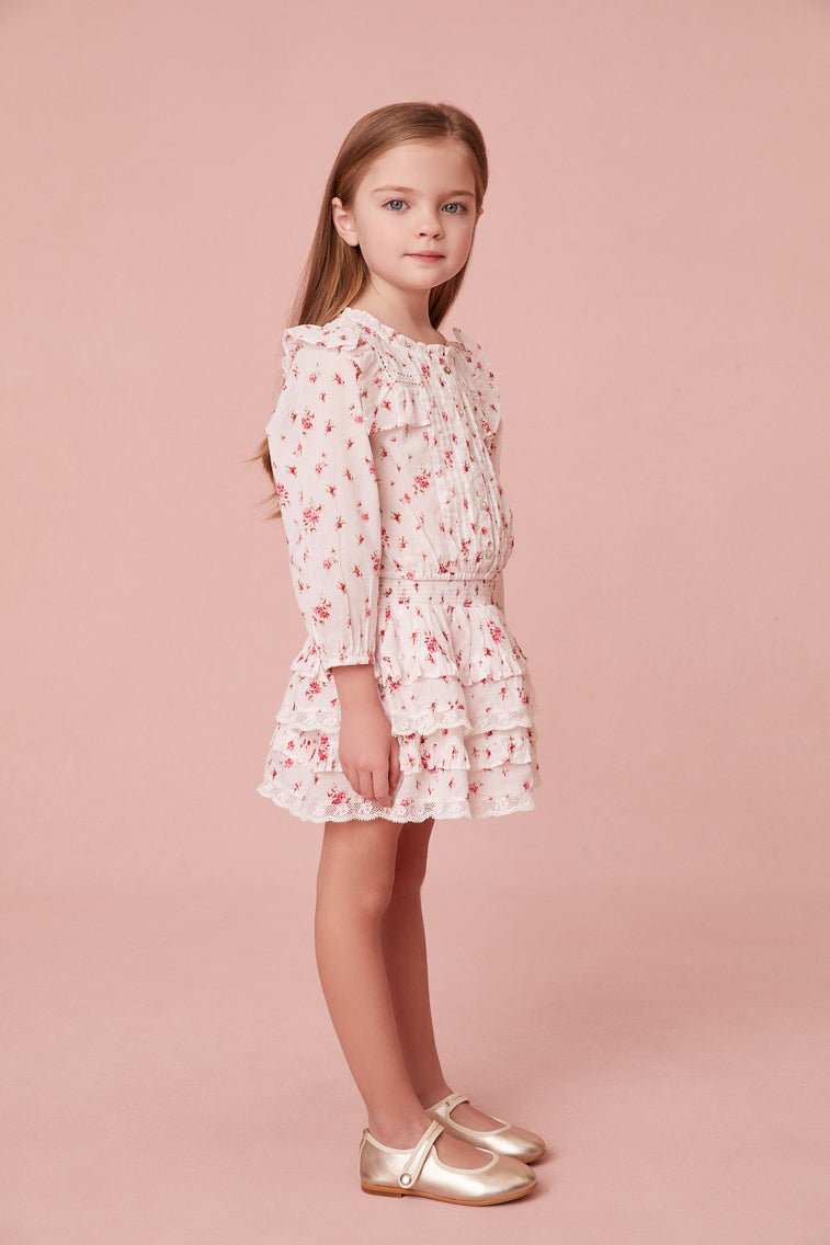 Floral print blouse featuring intricate custom lace detail at the round neckline and throughout the ruffle-adorned bib, airy long sleeves and small embroidery detail all over.