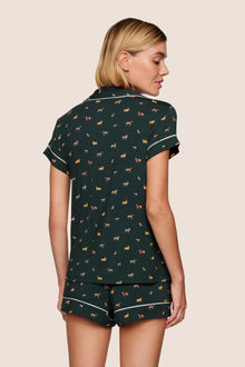 Model is wearing Gisele Printed TENCEL Modal Shortie Short PJ Set  in Holiday Dogs Pine/Ivory