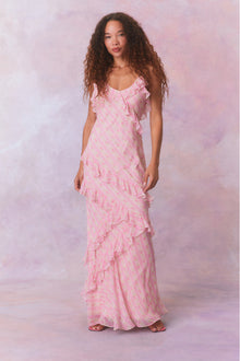 Pink floral chiffon maxi dress with spaghetti straps and ruffles that descend into the maxi skirt.
