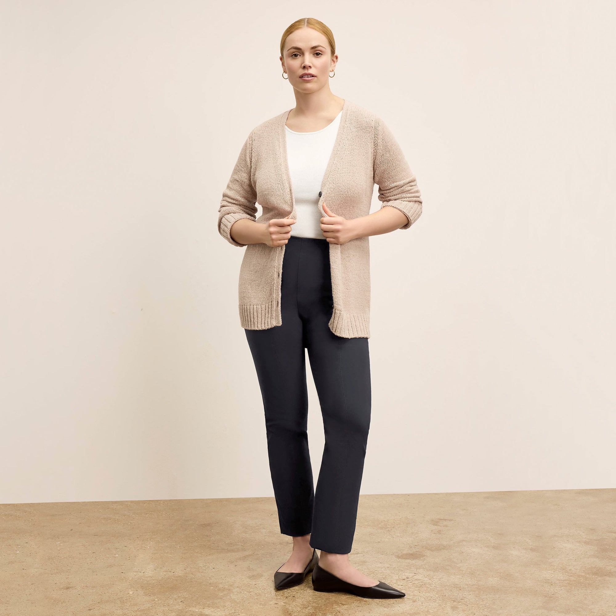 front image of a woman standing wearing the Foster Pant—Everstretch in Black | Exclude