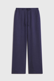 Woman wearing blue linen pants with a tie waist
