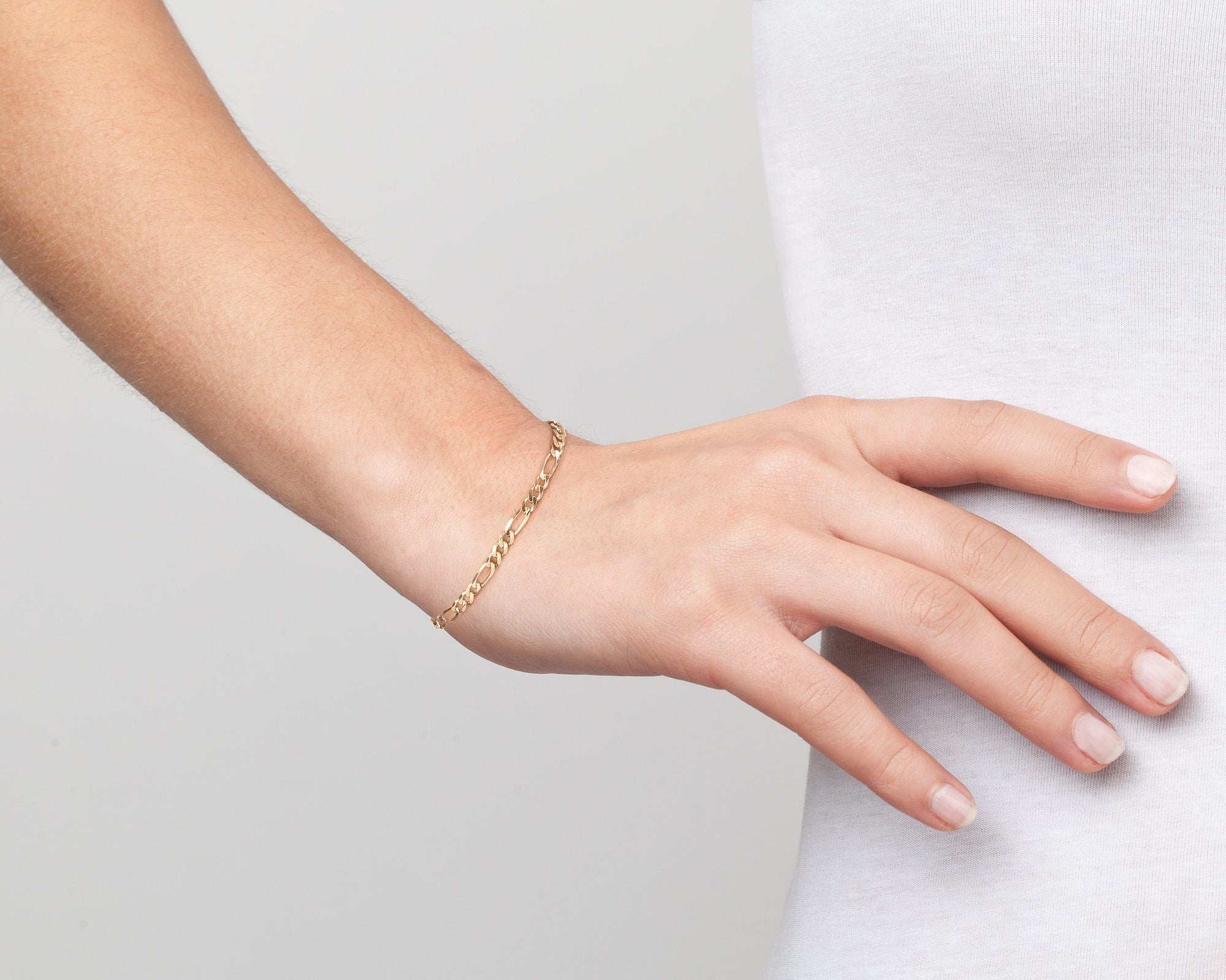 Model. Close of up woman waring old chain bracelet on white background