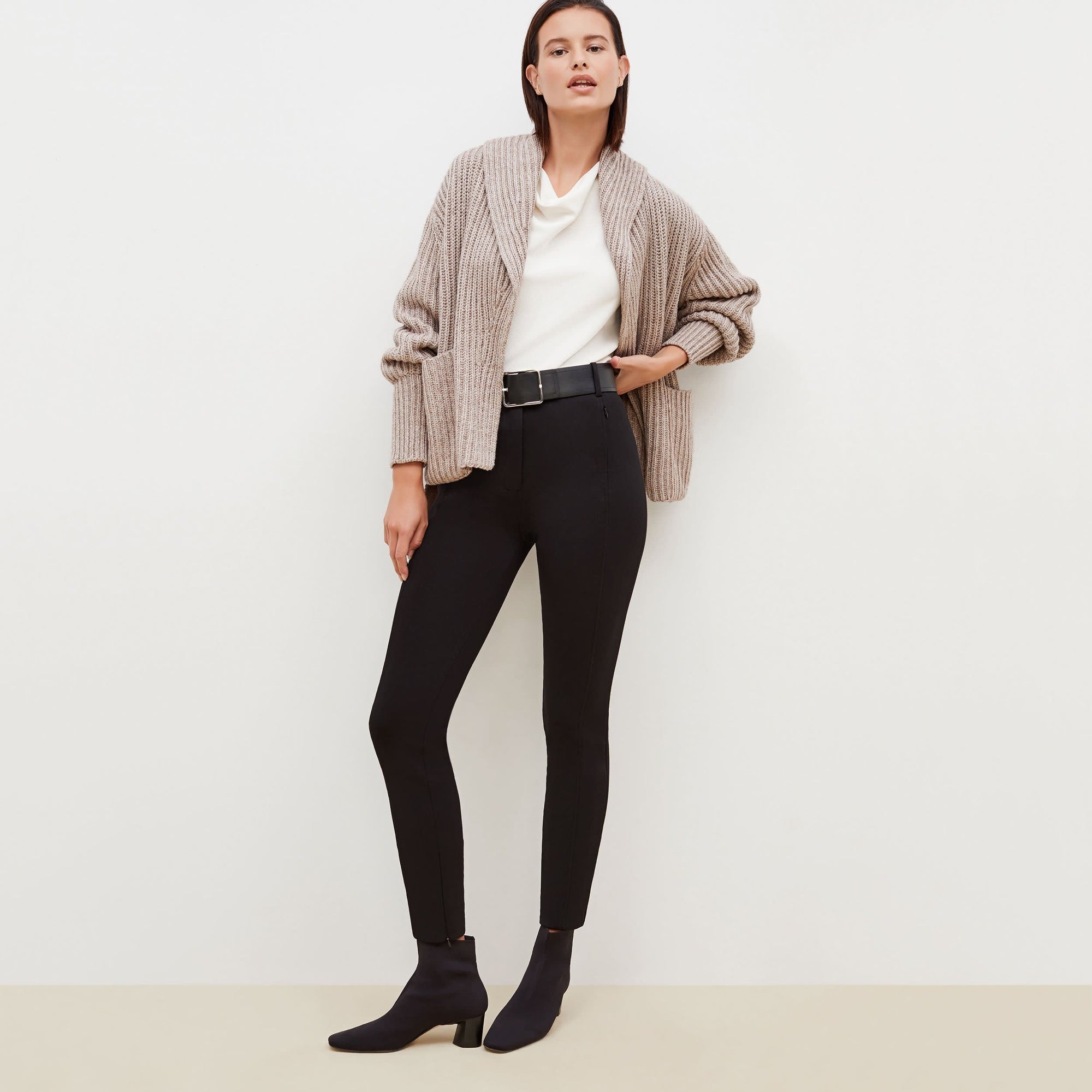 Front image of a woman standing wearing the Curie Pant--Worth in Black | Exclude