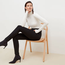 Side image of a woman sitting wearing the Curie Pant--Worth in Black