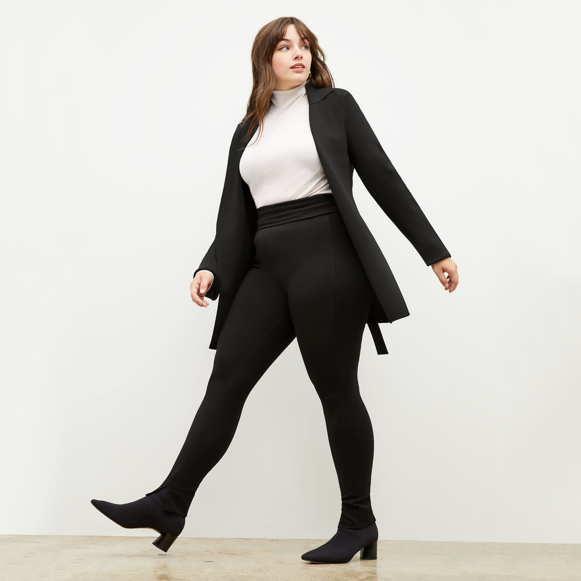 Front image of a woman standing wearing the stella legging in black | Exclude