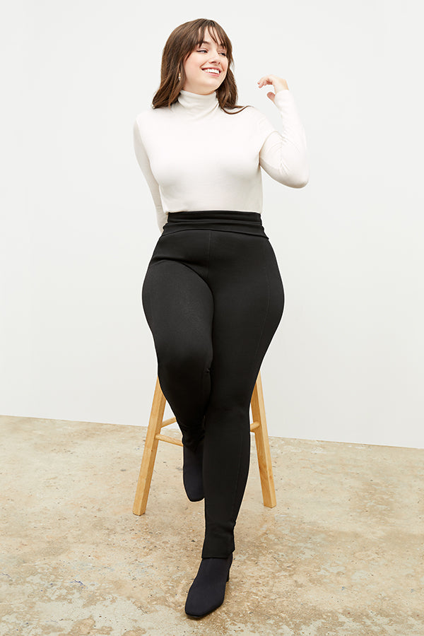 Front image of a woman standing wearing the stella legging in black | Exclude